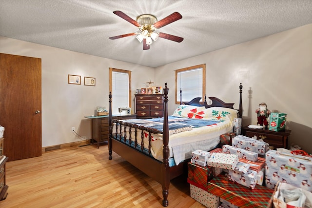 bedroom featuring ceiling fan, a textured ceiling, and light wood-type flooring