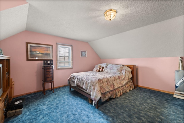 carpeted bedroom featuring a textured ceiling and vaulted ceiling