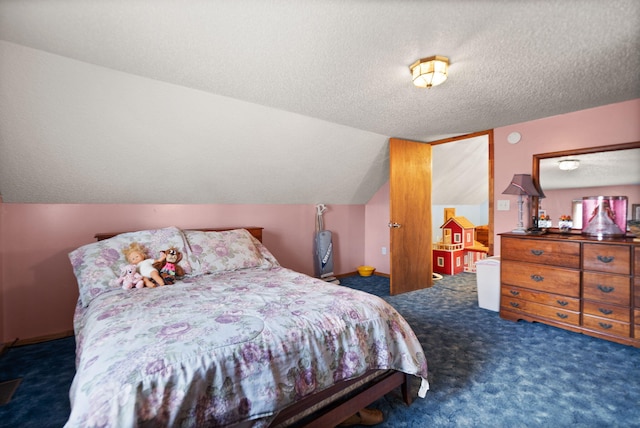 carpeted bedroom with a textured ceiling and vaulted ceiling