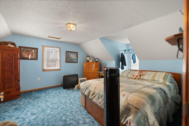 carpeted bedroom with a textured ceiling and vaulted ceiling