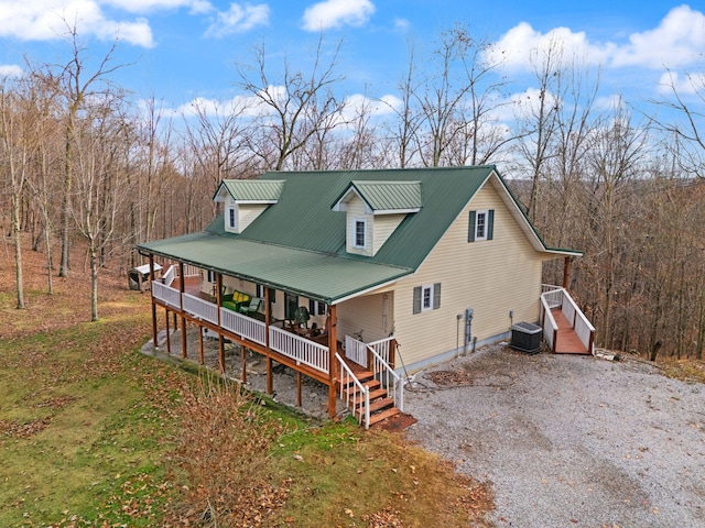 view of front facade featuring covered porch and central air condition unit