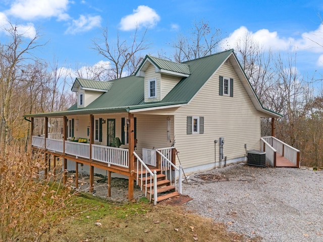 rear view of property with covered porch and central AC