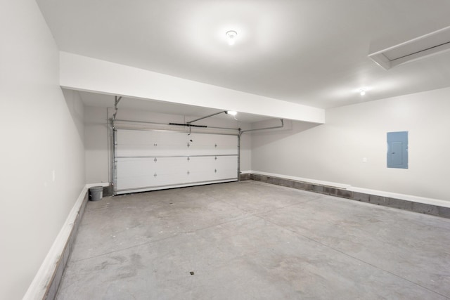 garage featuring electric panel and baseboards