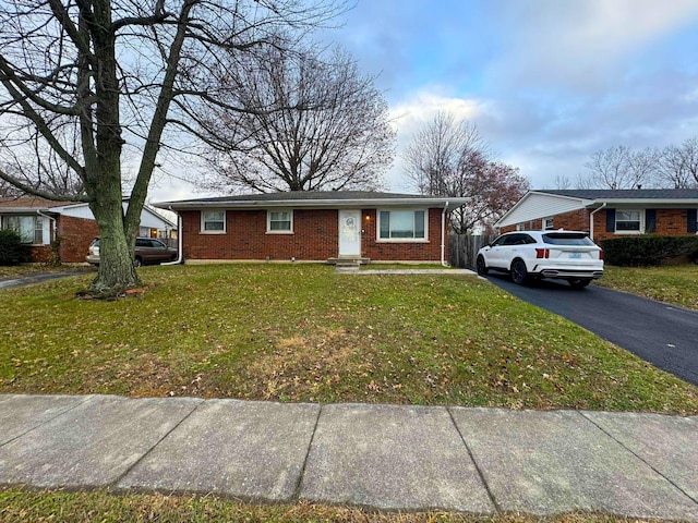 ranch-style home with a front lawn