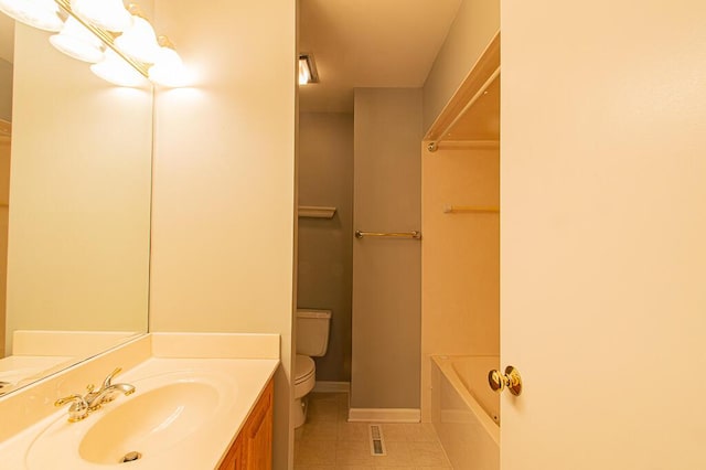 bathroom featuring vanity, tile patterned flooring, a bathtub, and toilet