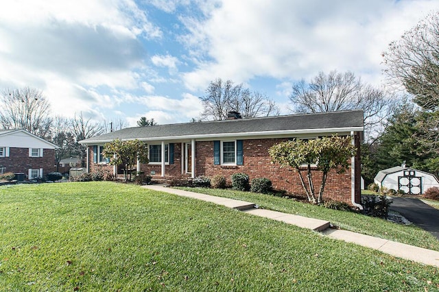 single story home with a shed and a front lawn