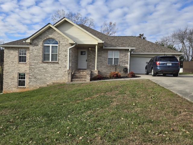 view of front of property with a front yard and a garage