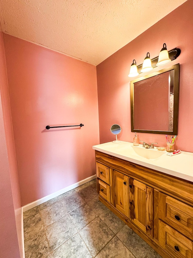 bathroom featuring vanity and a textured ceiling