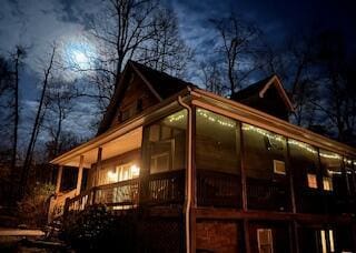 view of side of property featuring a sunroom