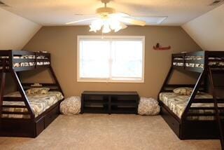 carpeted bedroom with ceiling fan and lofted ceiling