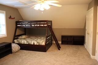 carpeted bedroom featuring ceiling fan and lofted ceiling