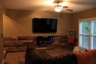 living room featuring hardwood / wood-style floors and ceiling fan