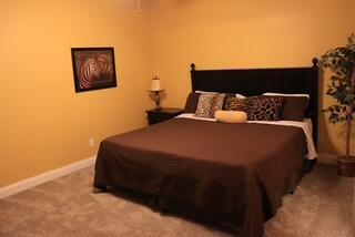 bedroom featuring light colored carpet