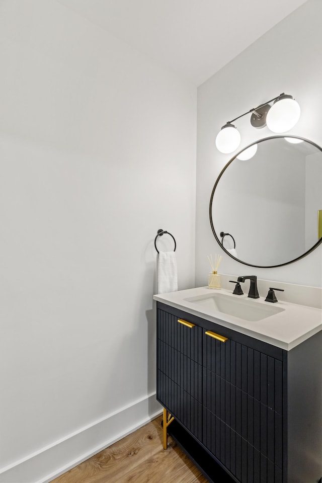 bathroom with hardwood / wood-style flooring and vanity