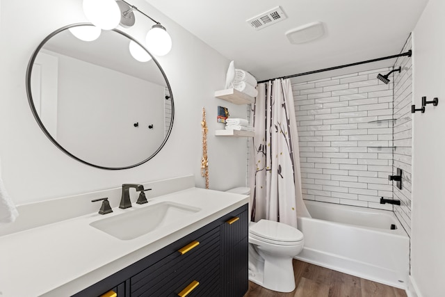 full bathroom with shower / tub combo with curtain, vanity, wood-type flooring, and toilet