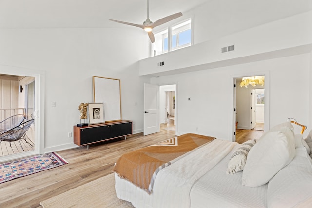 bedroom featuring connected bathroom, ceiling fan, light hardwood / wood-style flooring, and high vaulted ceiling