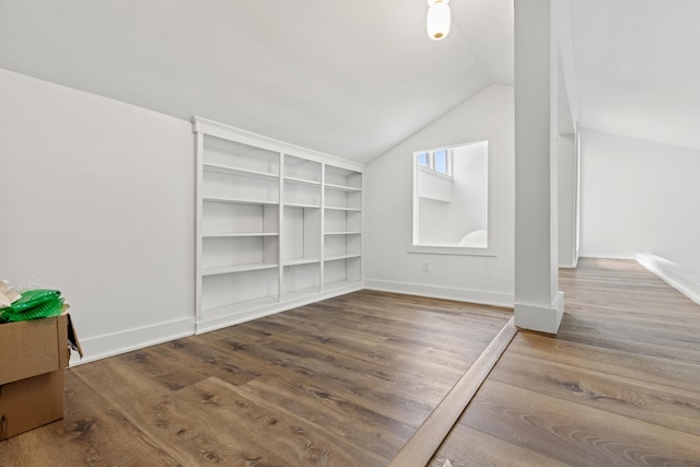 interior space featuring hardwood / wood-style flooring and lofted ceiling