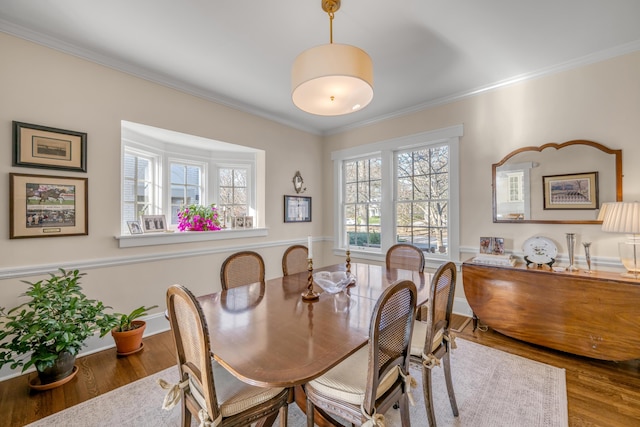 dining room featuring wood-type flooring and ornamental molding