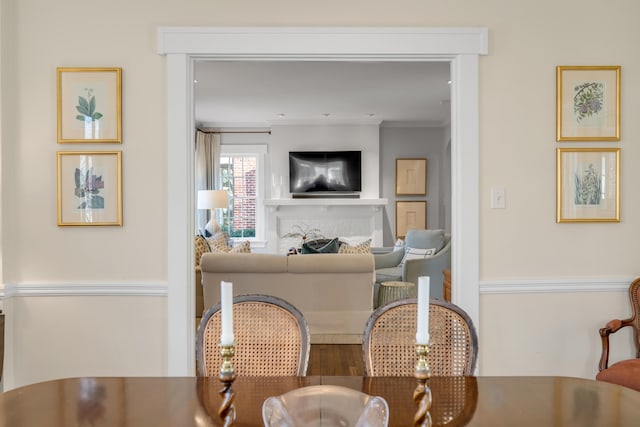 dining space featuring crown molding