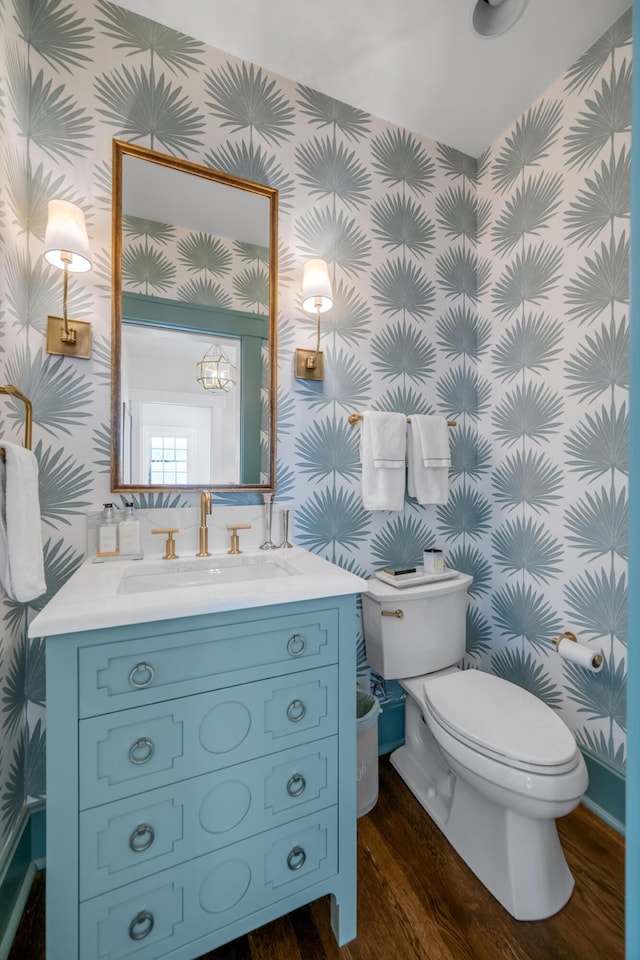 bathroom featuring vanity, hardwood / wood-style flooring, and toilet