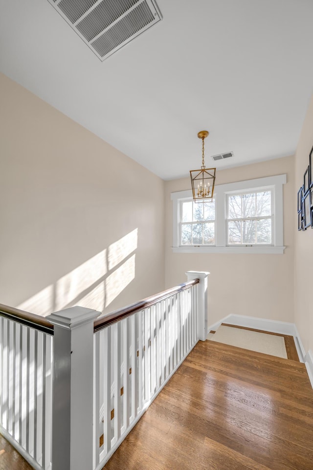 interior space featuring hardwood / wood-style floors and a chandelier