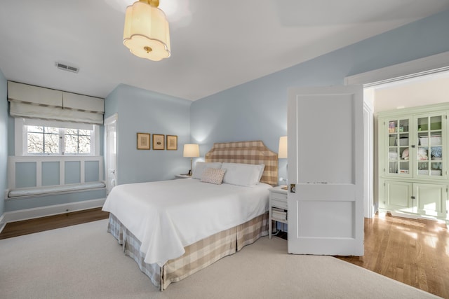 bedroom with wood-type flooring