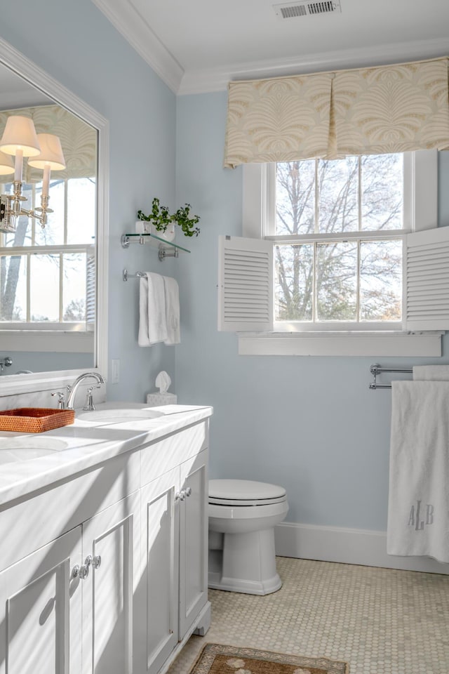 bathroom with tile patterned flooring, vanity, ornamental molding, and toilet