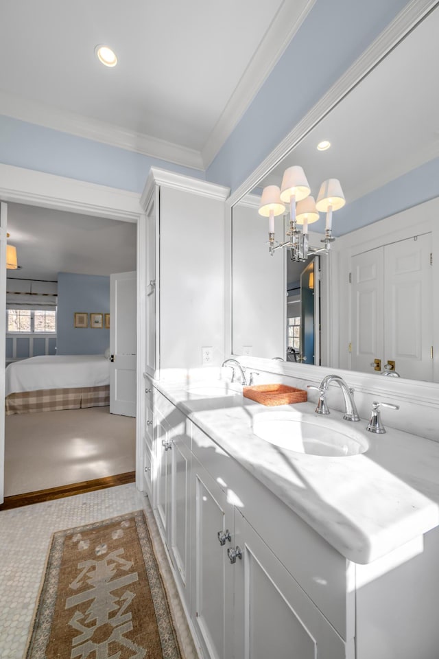 bathroom with tile patterned floors, vanity, ornamental molding, and a notable chandelier