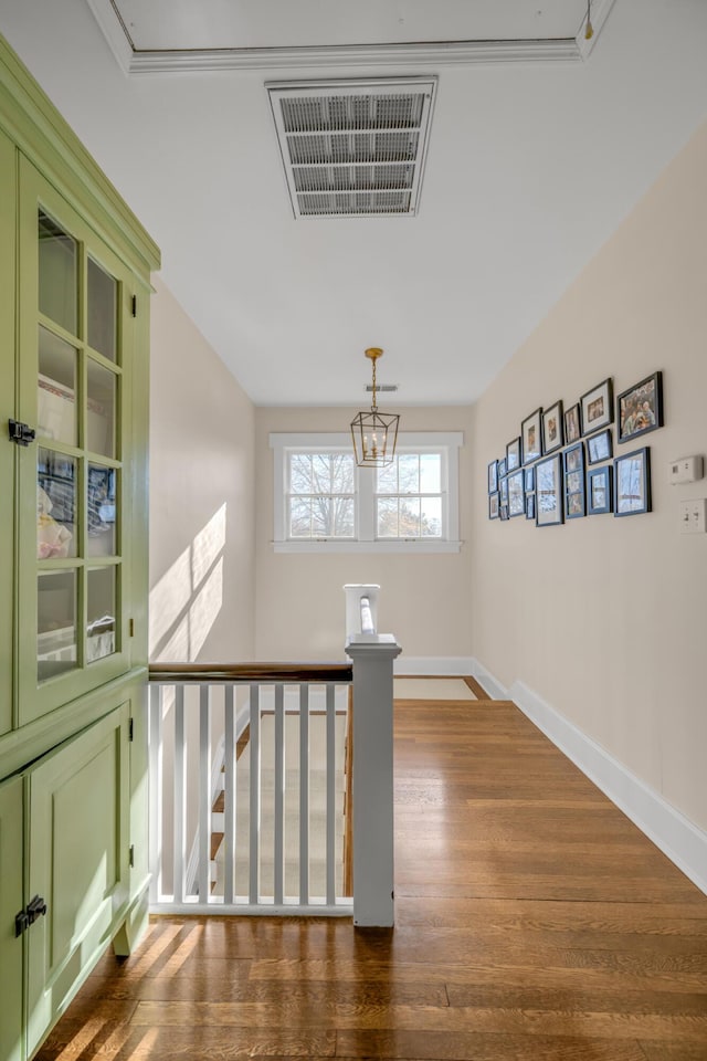 corridor featuring a chandelier and dark hardwood / wood-style flooring