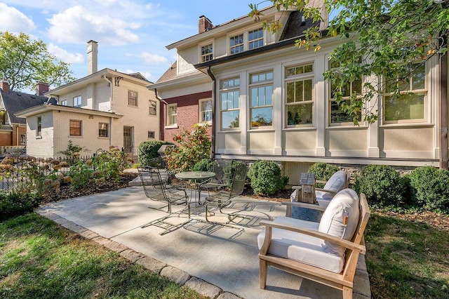 rear view of property featuring a patio area