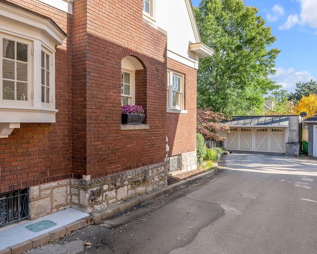 view of property exterior featuring a garage and an outdoor structure