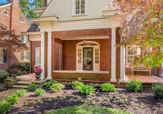 view of exterior entry with a porch