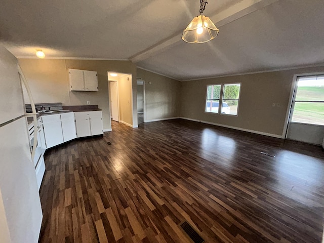 kitchen featuring white cabinetry, hanging light fixtures, dark wood-type flooring, lofted ceiling with beams, and white refrigerator