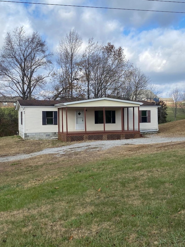 view of front of property featuring covered porch and a front yard