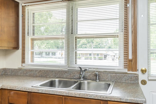 kitchen with backsplash, sink, and a wealth of natural light