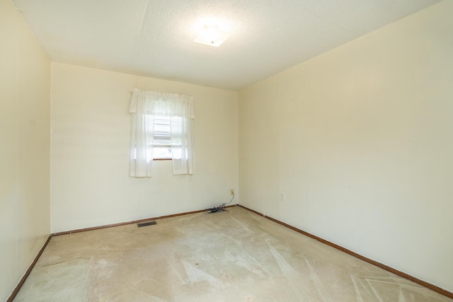 spare room with carpet floors and a textured ceiling