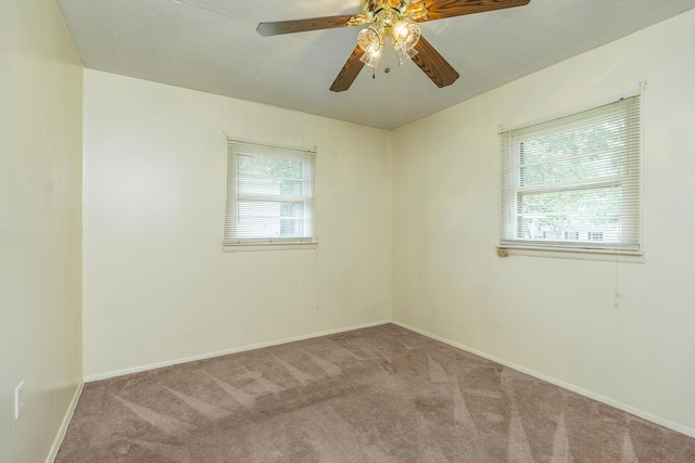 carpeted empty room featuring ceiling fan