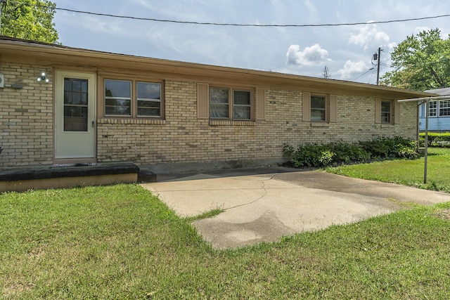 back of house with a yard and a patio