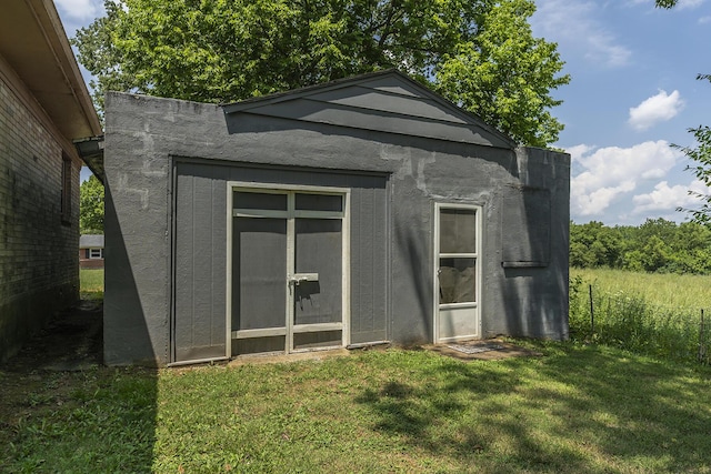 view of outbuilding featuring a yard