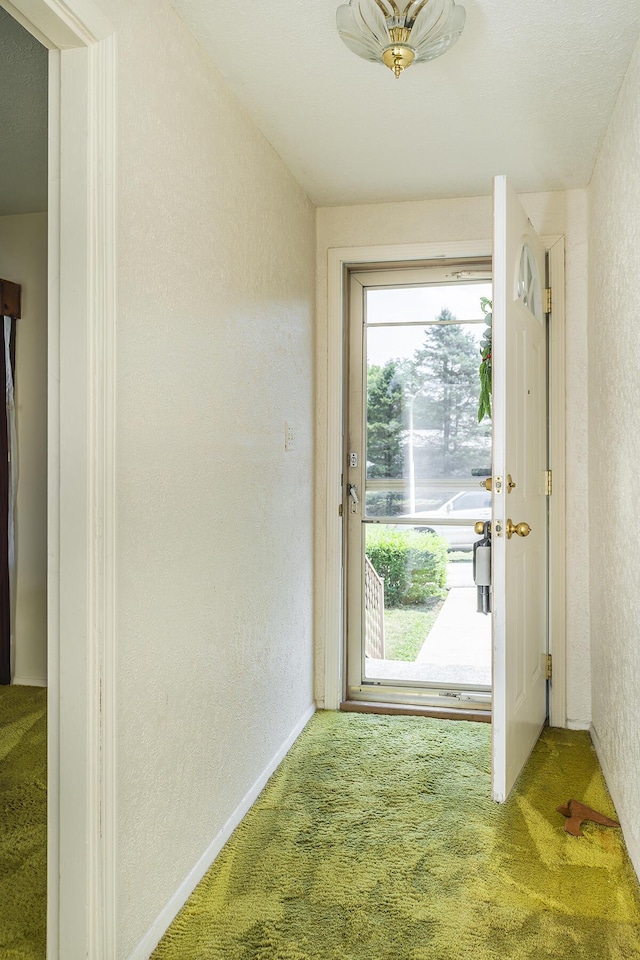 doorway to outside featuring carpet floors