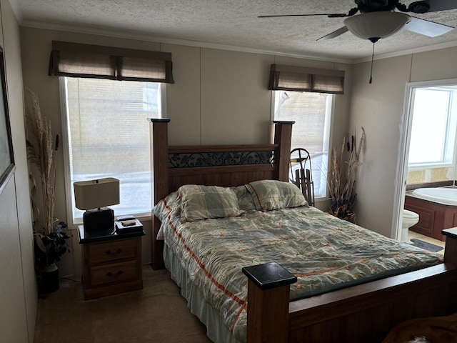 carpeted bedroom with a textured ceiling, ceiling fan, and ornamental molding