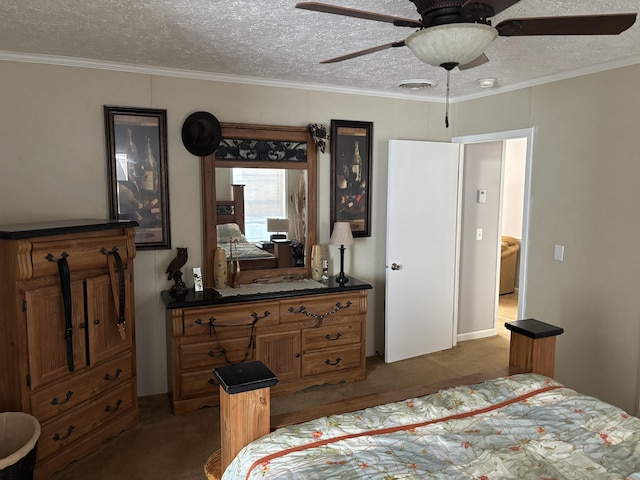 bedroom with a textured ceiling, ceiling fan, crown molding, and dark colored carpet