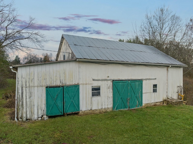 outdoor structure at dusk with a yard