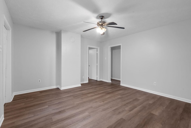 unfurnished room featuring ceiling fan, dark wood-type flooring, and a textured ceiling