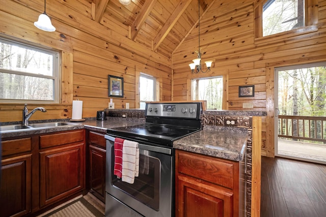 kitchen featuring electric range, sink, high vaulted ceiling, a notable chandelier, and wooden walls