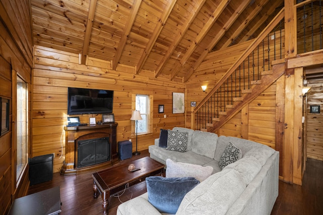 559 Eagle Ridge Rd, Campton, KY 41301 - living area with a wooden ceiling with exposed beams, stairs, wood walls, a glass covered fireplace, and hardwood / wood-style floors