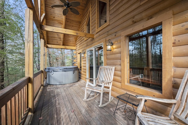 deck featuring ceiling fan and a hot tub