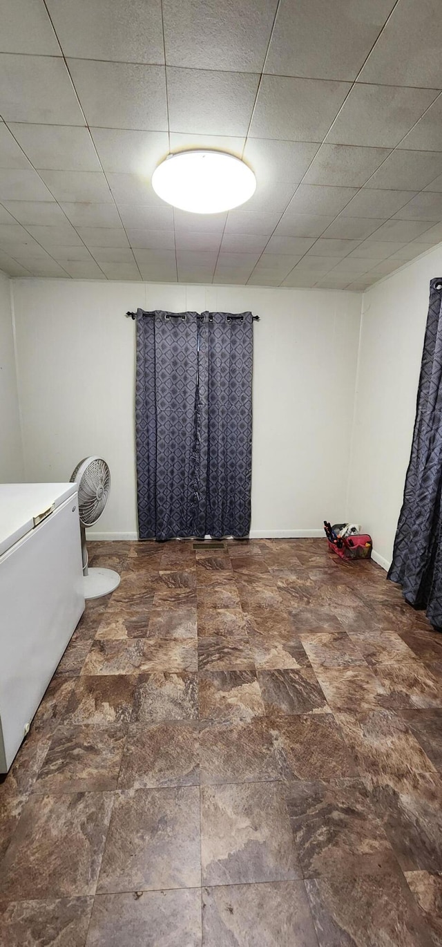 bathroom featuring a drop ceiling