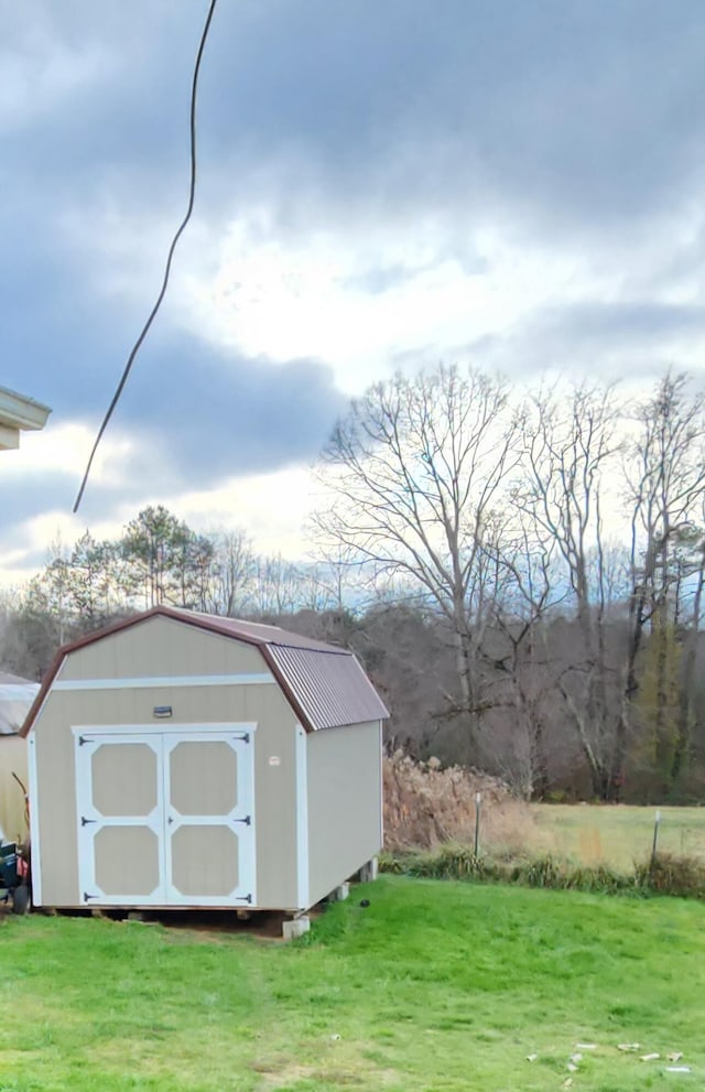 view of outbuilding featuring a yard