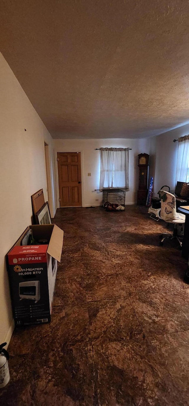 living area with a textured ceiling